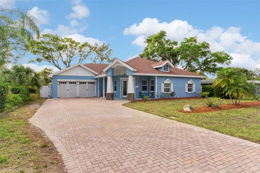 12080 143rd Street North Largo, FL 33774 - Photo 2 of 49 a front view of a house with a yard and garage
