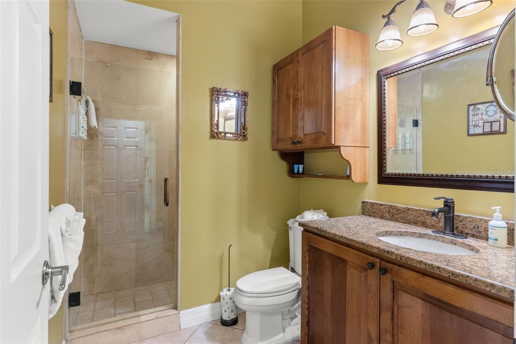 12080 143rd Street North Largo, FL 33774 - Photo 24 of 49 a bathroom with a granite countertop sink toilet and shower