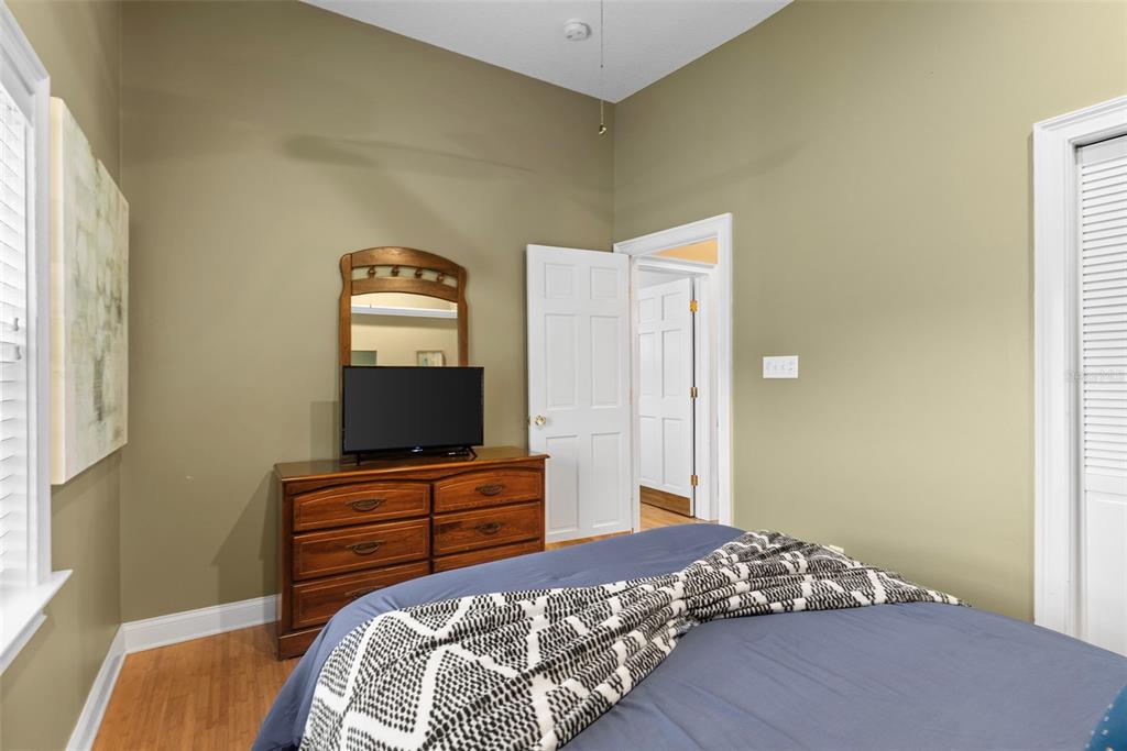 12080 143rd Street North Largo, FL 33774 - Photo 29 of 49 a bedroom with a bed and a flat screen tv