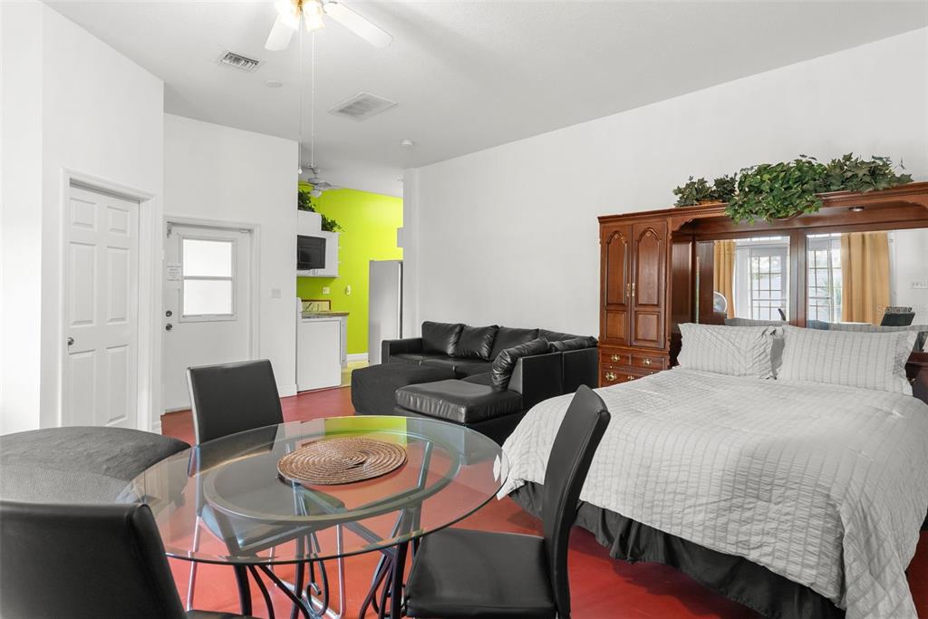 12080 143rd Street North Largo, FL 33774 - Photo 33 of 49 a bedroom with a bed a table and chair with wooden floor