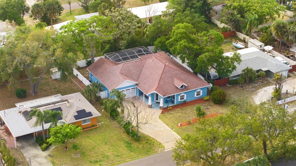 12080 143rd Street North Largo, FL 33774 - Photo 39 of 49 an aerial view of a house with swimming pool and large trees
