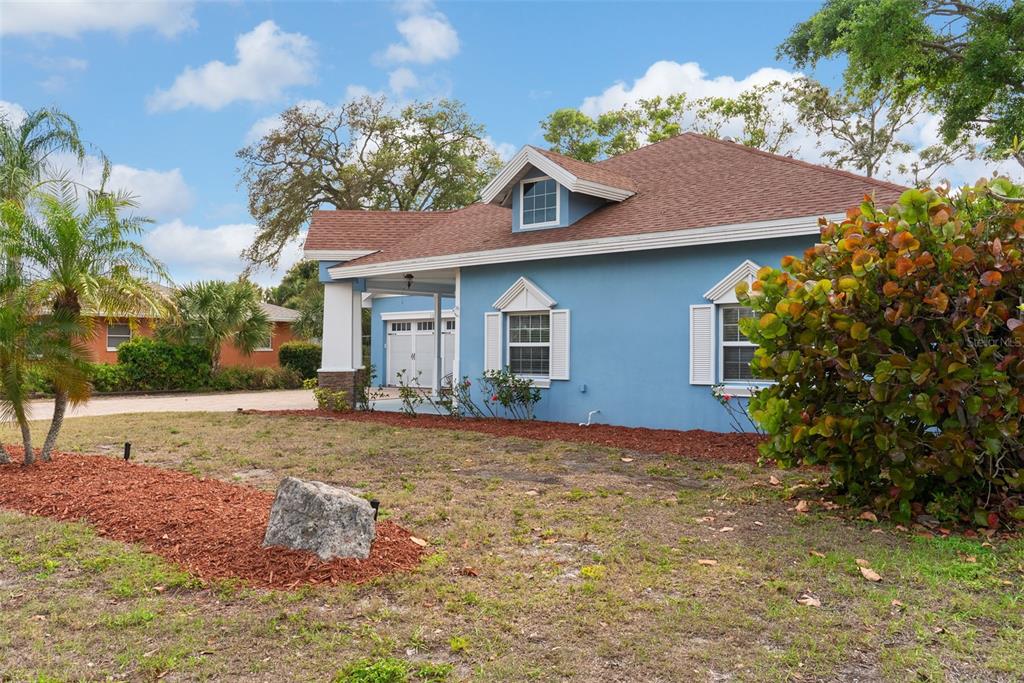 12080 143rd Street North Largo, FL 33774 - Photo 4 of 49 a view of a house with a yard and potted plants