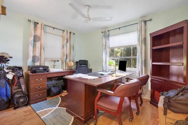 a view of a workspace with furniture and a window