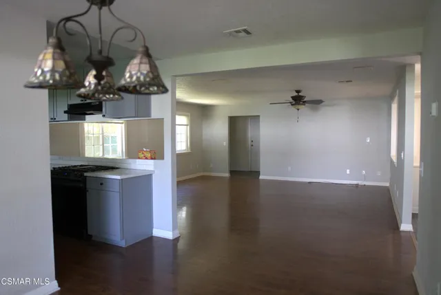 a kitchen with a sink and chandelier