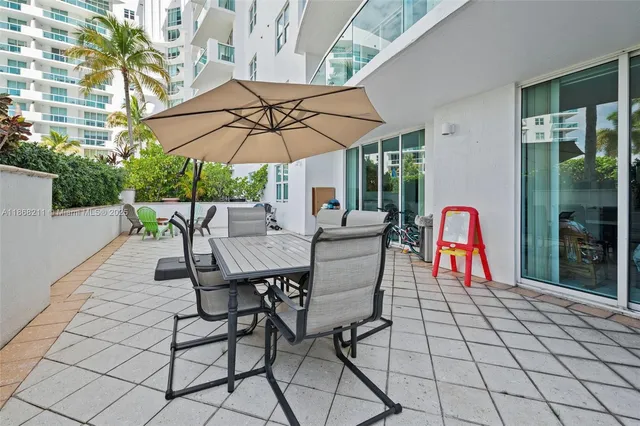 a patio with a patio table and chairs