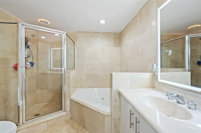 a bathroom with a bathtub shower sink and mirror