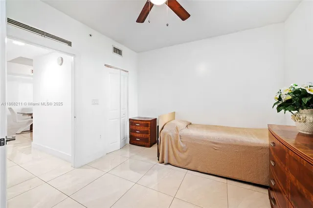 a room with a couch and a potted plant on the wall