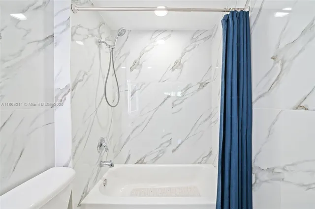 a bathroom with a bathtub and shower