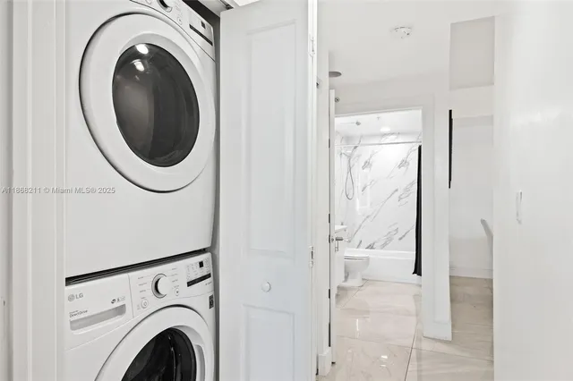 a view of a hallway with washer and dryer