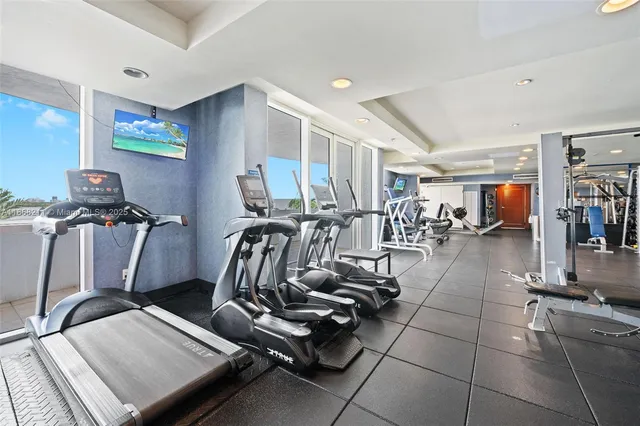 a room with gym equipment and large mirror