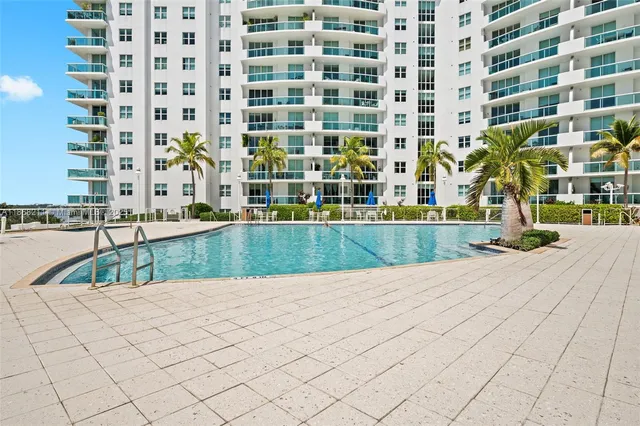 a view of building with a swimming pool