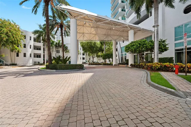 a view of a patio with a table and chairs under an umbrella