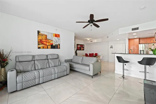 a living room with furniture and a ceiling fan