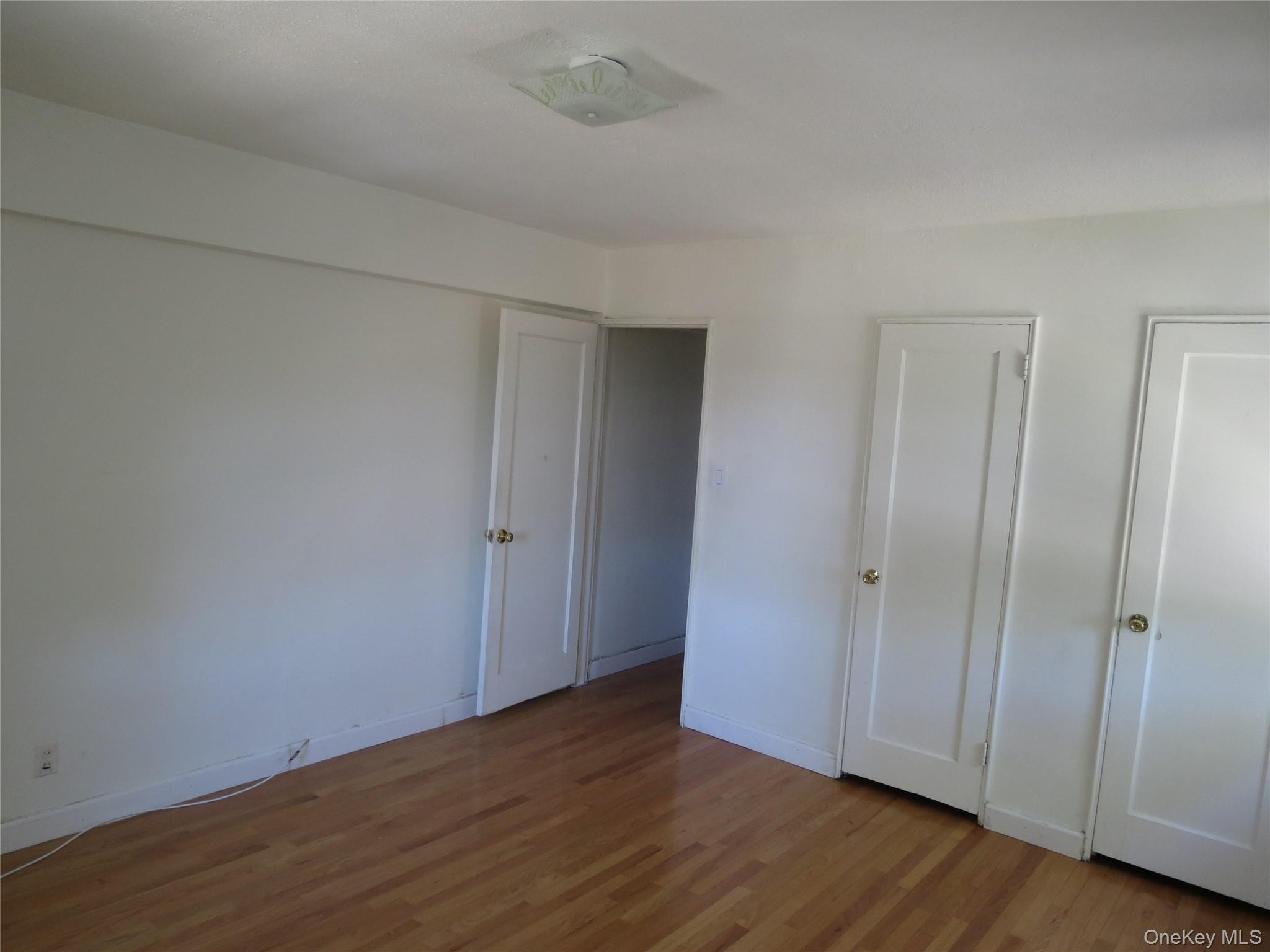 147-14 84th Road, Unit 2A Queens, NY 11435 - Photo 17 of 36 Facing Bedroom Entrance Door And Closets From Inside