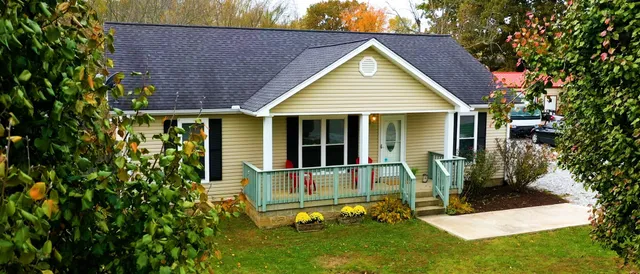 a front view of a house with a yard patio and fire pit
