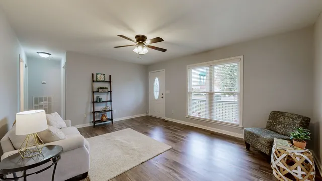 a living room with furniture and wooden floor