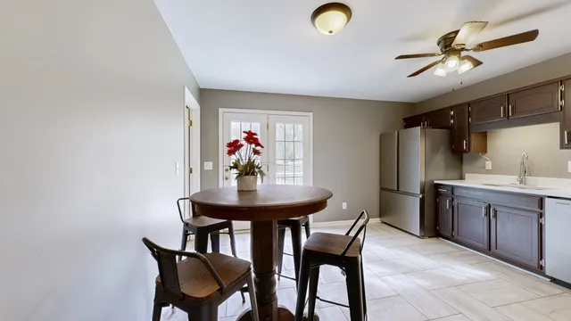 a view of a dining room with furniture and a chandelier