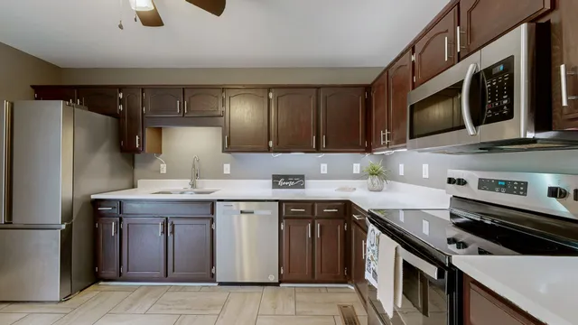 a kitchen with a sink stove and refrigerator