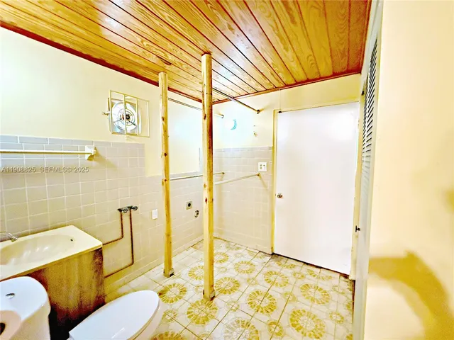 a bathroom with a sink mirror toilet and bathtub