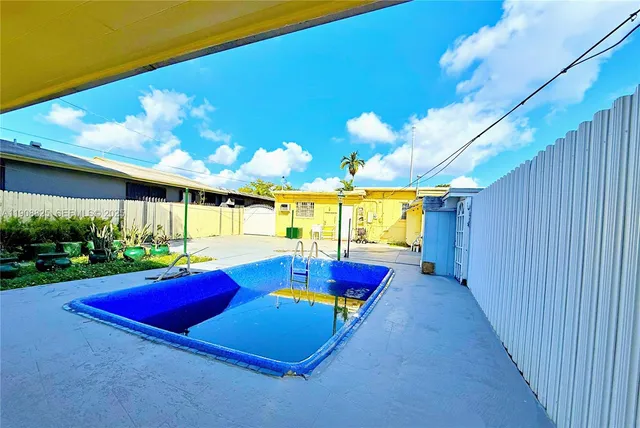 a view of a pool with a backyard