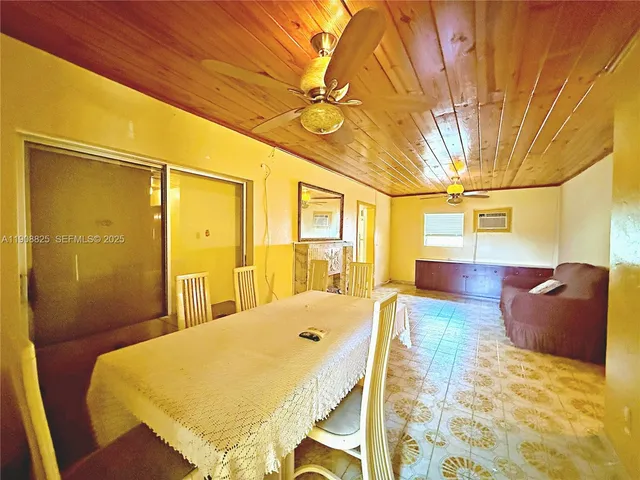 a spacious bedroom with a bed and wooden floor