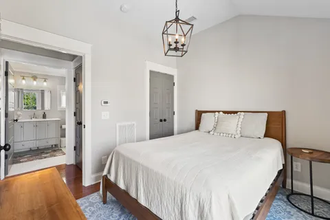 a bedroom with a bed and a chandelier
