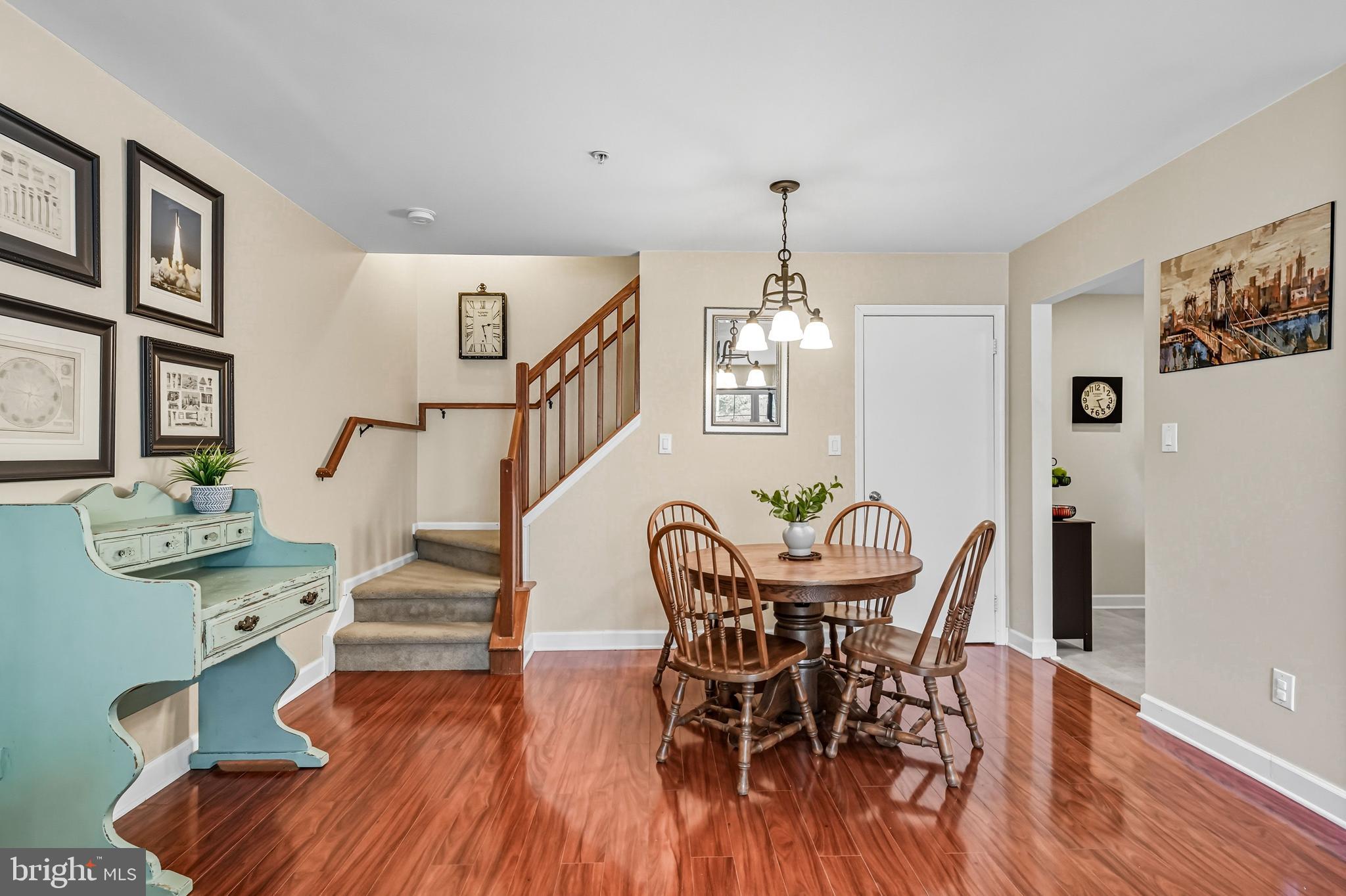 1603 Wharton Road Mount Laurel, NJ 08054 - Photo 11 of 39 a view of a dining room with furniture a chandelier and wooden floor