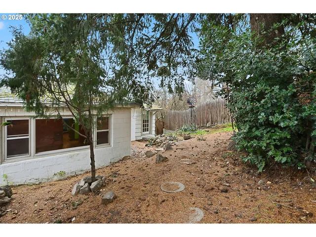 a view of backyard of house and car parked