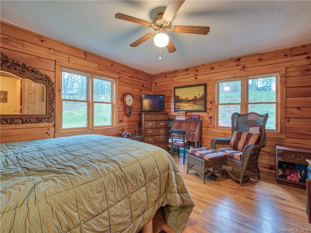 24 Thistle Ridge Clyde, NC 28721 - Photo 14 of 18 a bed room with a bed and a chair