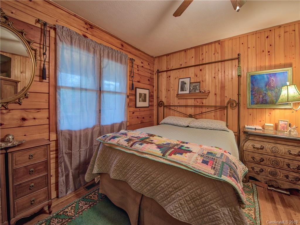 24 Thistle Ridge Clyde, NC 28721 - Photo 16 of 18 a bedroom with a bed and a dresser