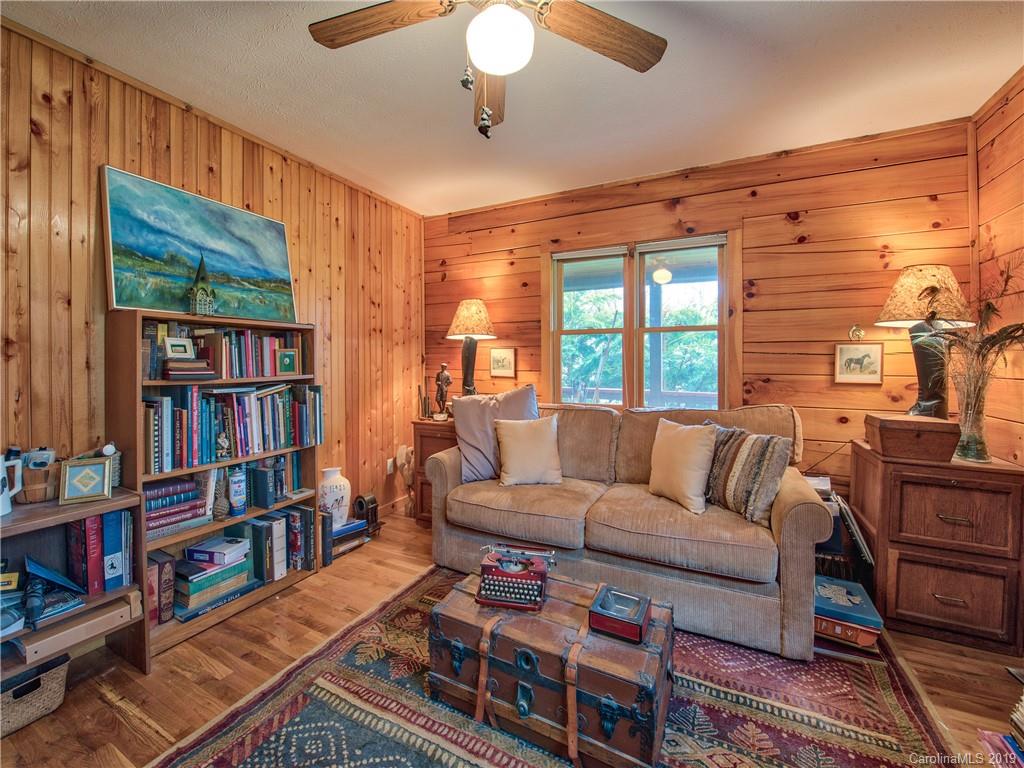 24 Thistle Ridge Clyde, NC 28721 - Photo 17 of 18 a living room with furniture a rug and a book shelf