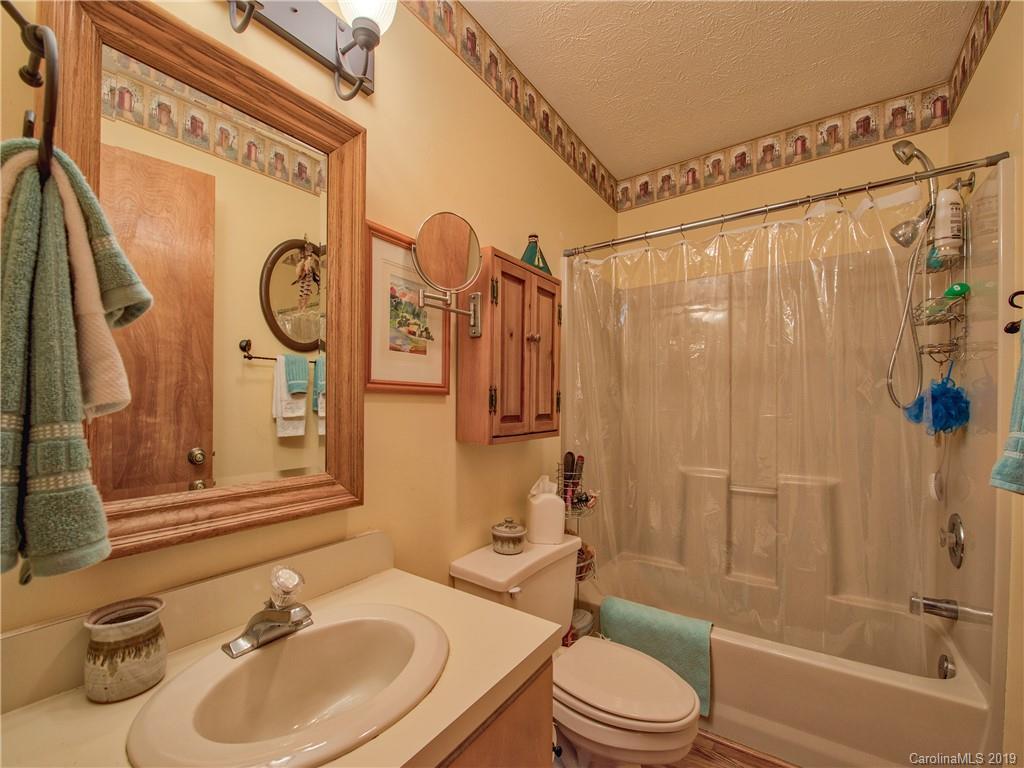 24 Thistle Ridge Clyde, NC 28721 - Photo 18 of 18 a bathroom with a sink toilet and shower
