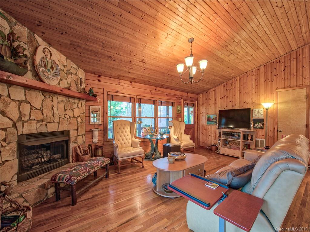 24 Thistle Ridge Clyde, NC 28721 - Photo 10 of 18 a living room with furniture a fireplace and a flat screen tv