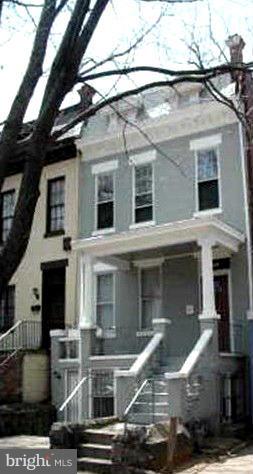 a front view of a house with parking space
