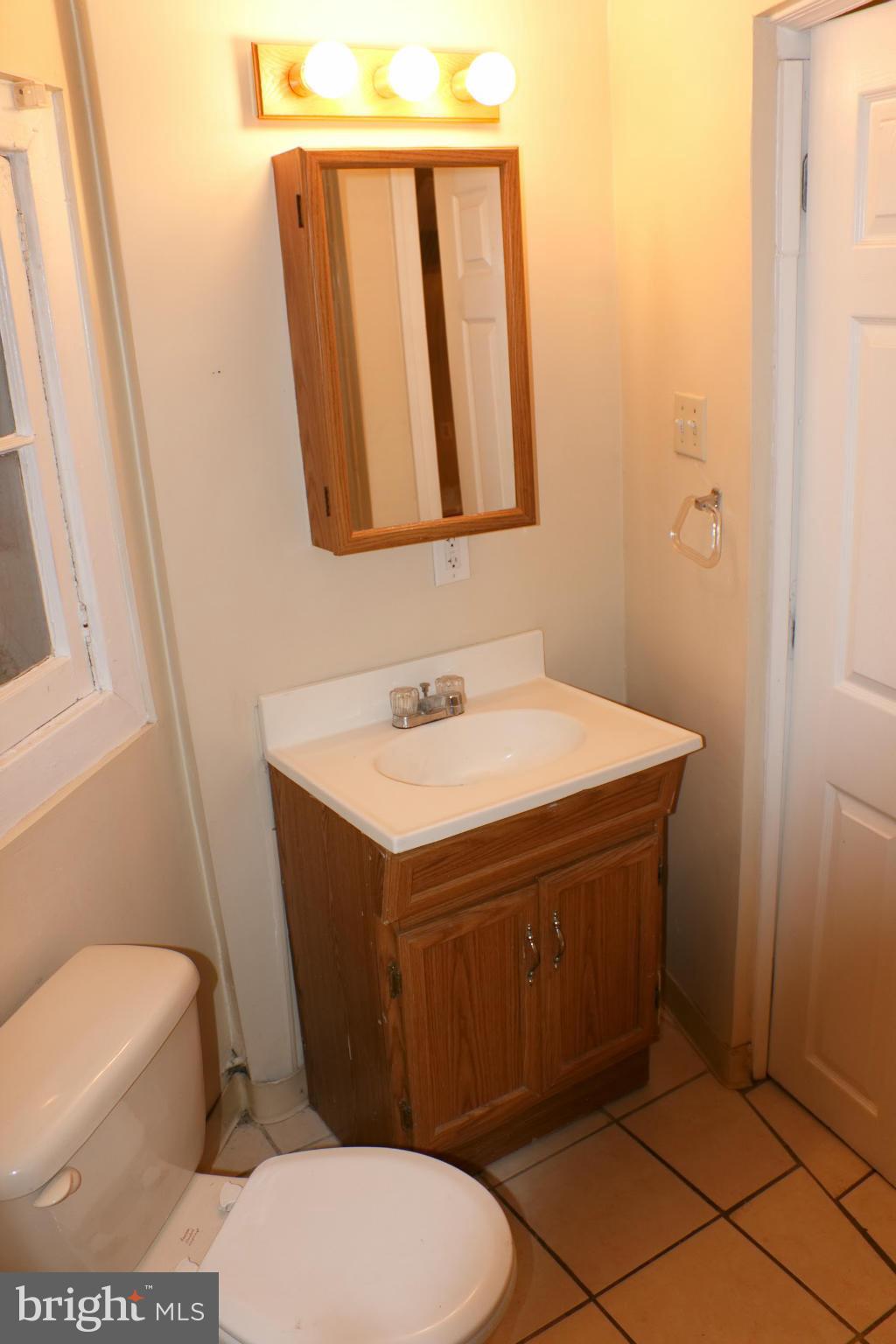 642 8th Street Northeast Washington, DC 20002 - Photo 17 of 29 a bathroom with a sink a toilet and mirror