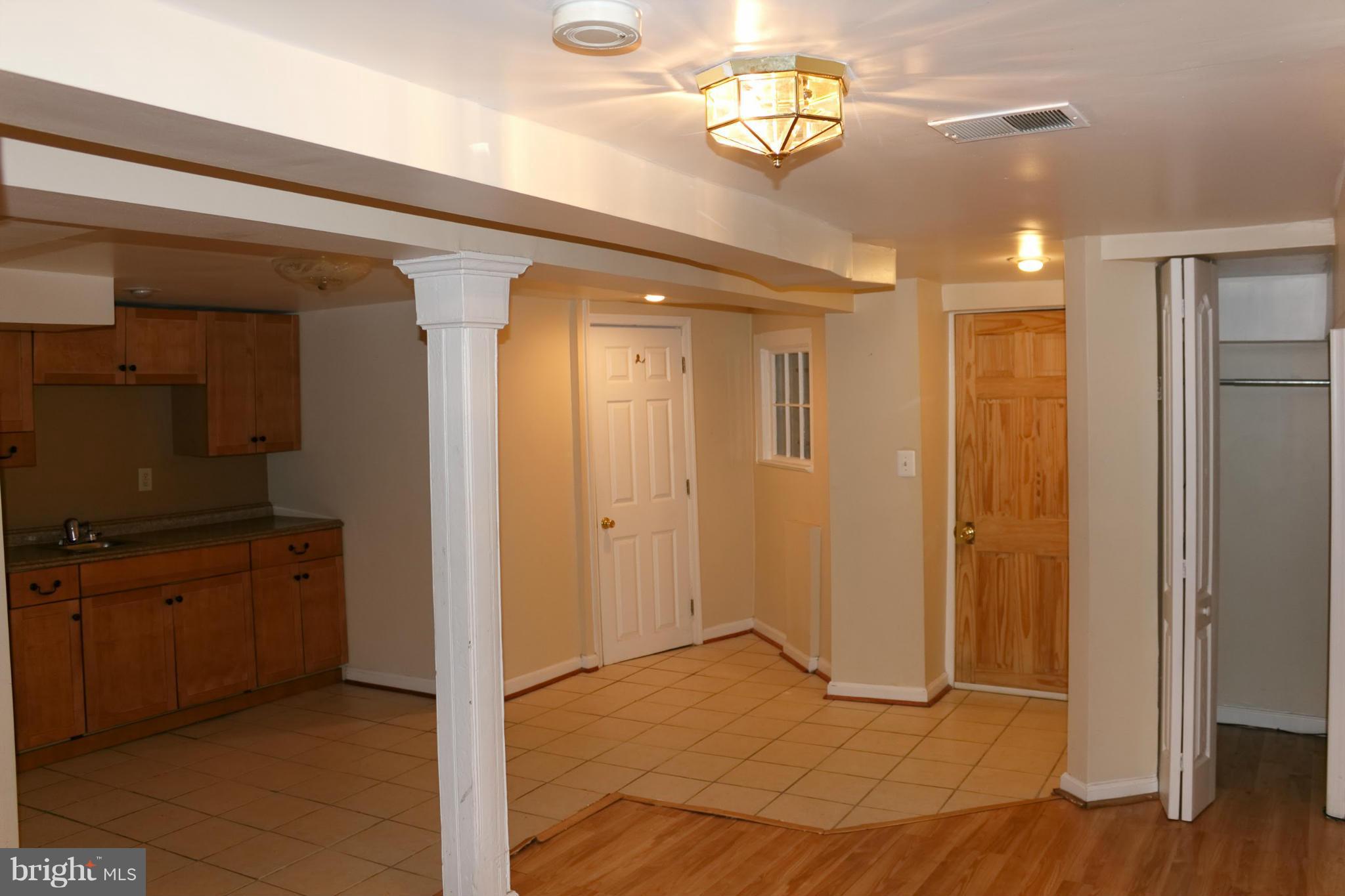 642 8th Street Northeast Washington, DC 20002 - Photo 23 of 29 a view of a hallway with wooden floor and a bathroom