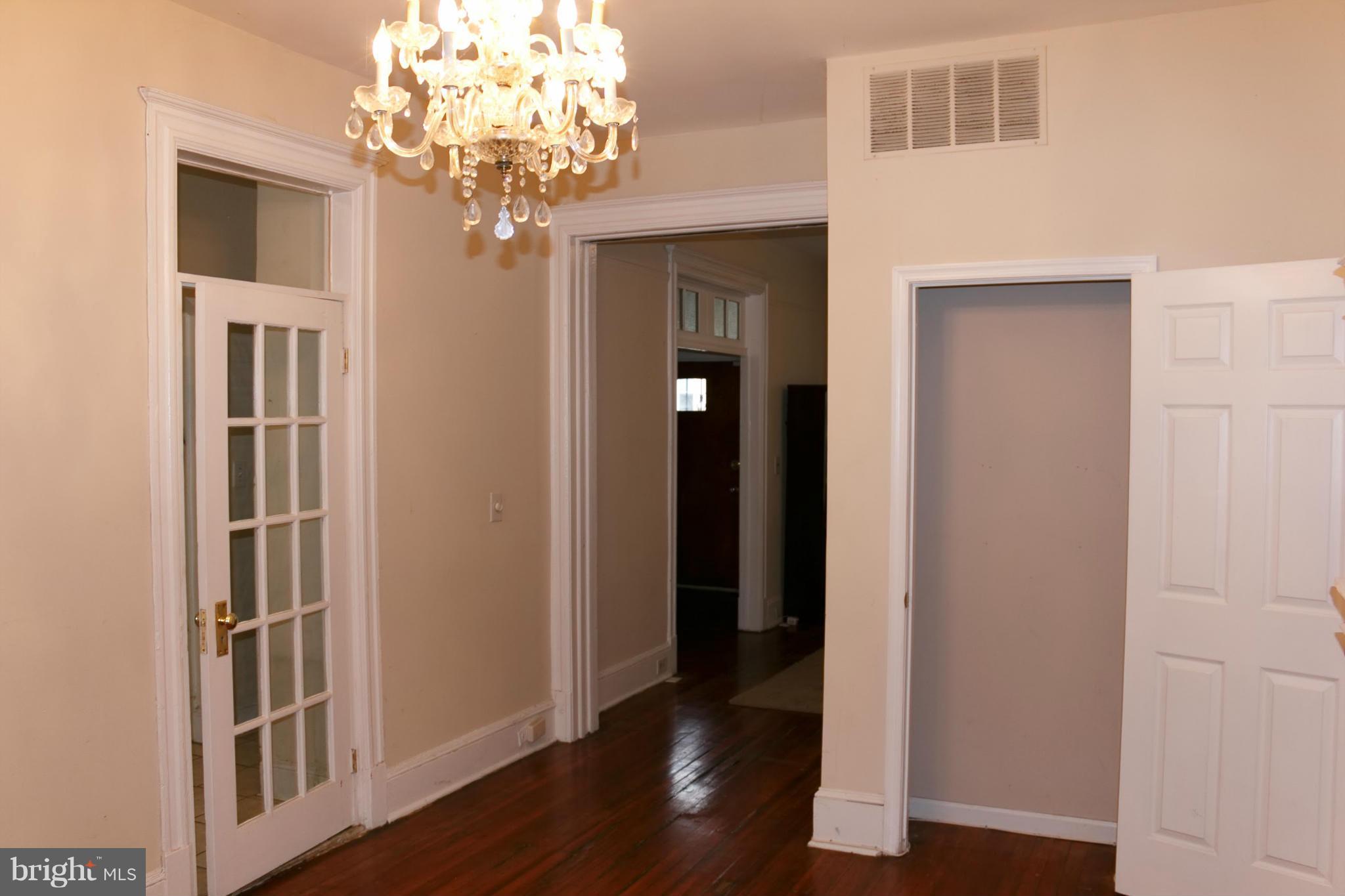 642 8th Street Northeast Washington, DC 20002 - Photo 8 of 29 a view of a hallway with wooden floor and a chandelier