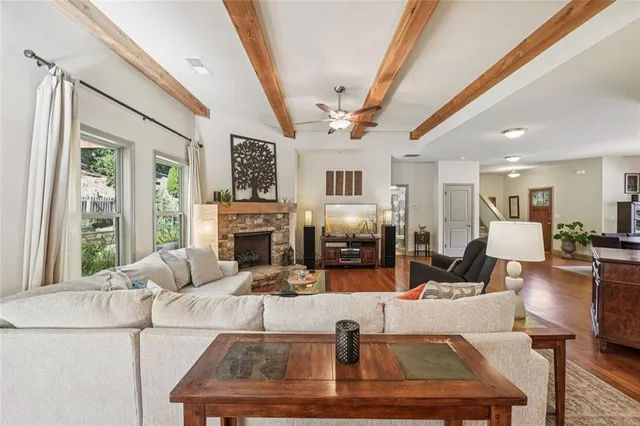 a large kitchen with stainless steel appliances kitchen island granite countertop a refrigerator and a sink