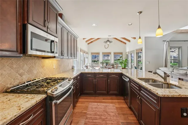 a bedroom with a large bed and a large window with balcony view