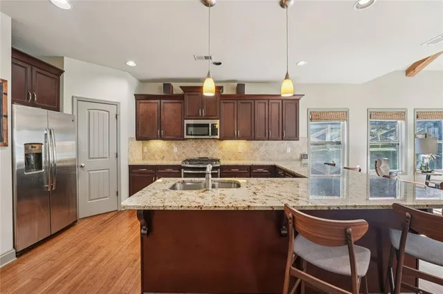 a bedroom with a large bed and a chandelier