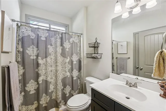 a spacious bedroom with a bed and a chandelier