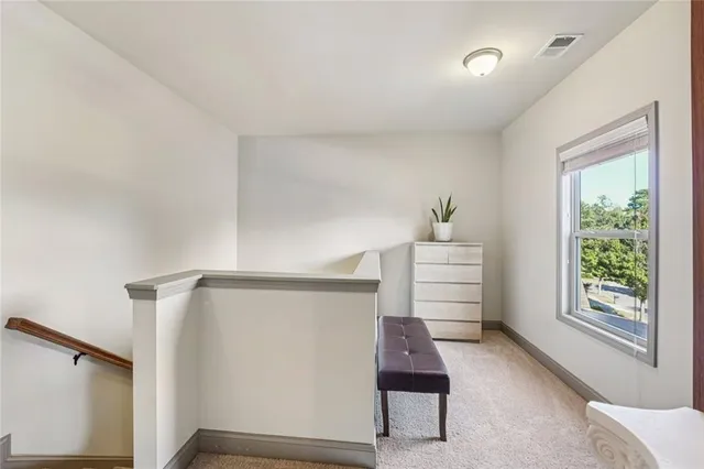 a spacious bathroom with a granite countertop double vanity sink a mirror and a bathtub
