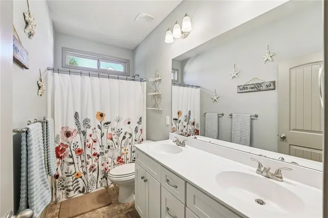 a bathroom with a toilet and a shower