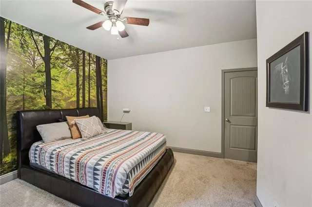 a view of a patio with couches and table and chairs with wooden floor and fence