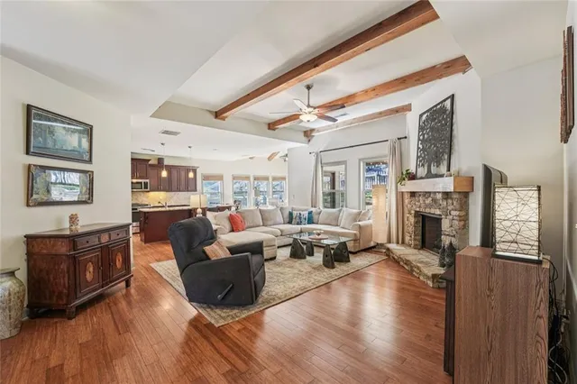 a living room with furniture a fireplace and a flat screen tv