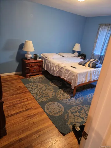 a bedroom with two beds and a dresser
