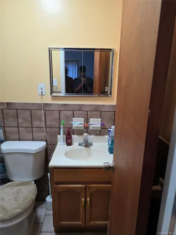 a bathroom with a toilet sink and mirror