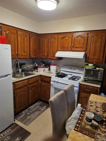 a kitchen with a stove a sink and a refrigerator
