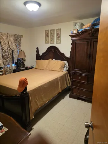a bedroom with a bed and dresser