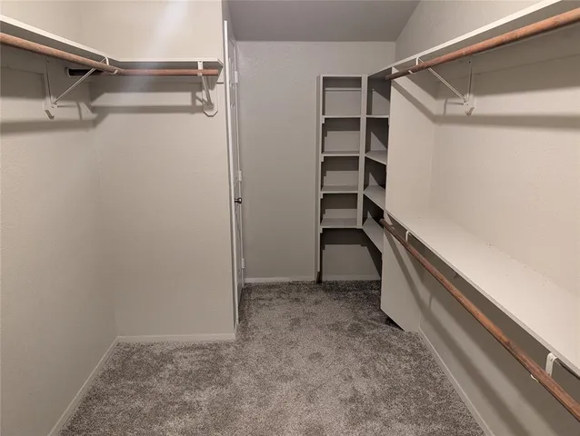 a room with wooden floor and cabinets